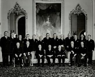 New Prime Minister, Louise St. Laurent, was sworn in yesterday succeeding Premier King. Shown from left, in front, are: J. G. Gardiner, C. D. Howe, Mr(...)