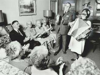 Good cheer: Rev. George Clement, and his wife, pearl, sing and play for members of the Golden Age Club of Richmond Hill. The couple, both in their 70s(...)