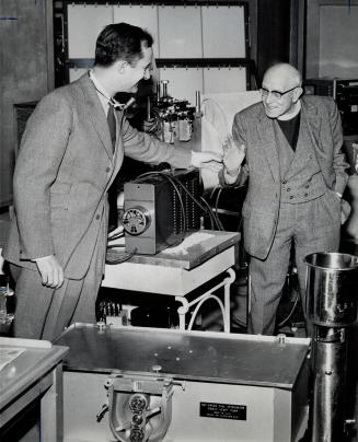 Archdeacon A. C. McCollum With Dr. Ray Heimbecker, Transistor-powered disc keeps his heart beating 73 times a minute