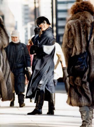 Donato Mendoza, left, a designer of men's and women's clothing, wears a big coat of his own design slit high in the back