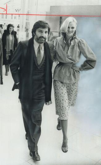 Manuel Ungaro, Paris designer, is shown with model wearing one of his spring outfits
