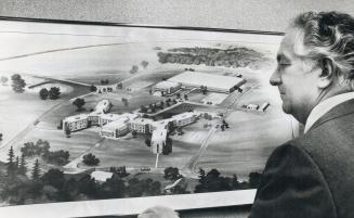 Eugene Rosam, chairman of Jehovah's Witnesses in Canada executive, looks over artist's impression of planned headquarters