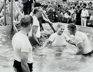 A Jehovah's Witness take the plunge in mass baptism yesterday of 181 members of Christian sect at Woodbine Race Track