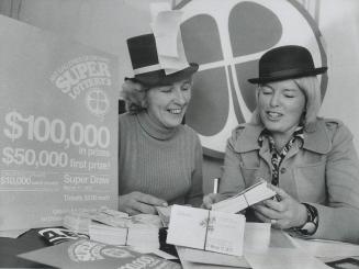Barbara Clarke, left, and Janet Conover check tickets, They are running a lottery to raise $1,000,000 for 10 art galleries