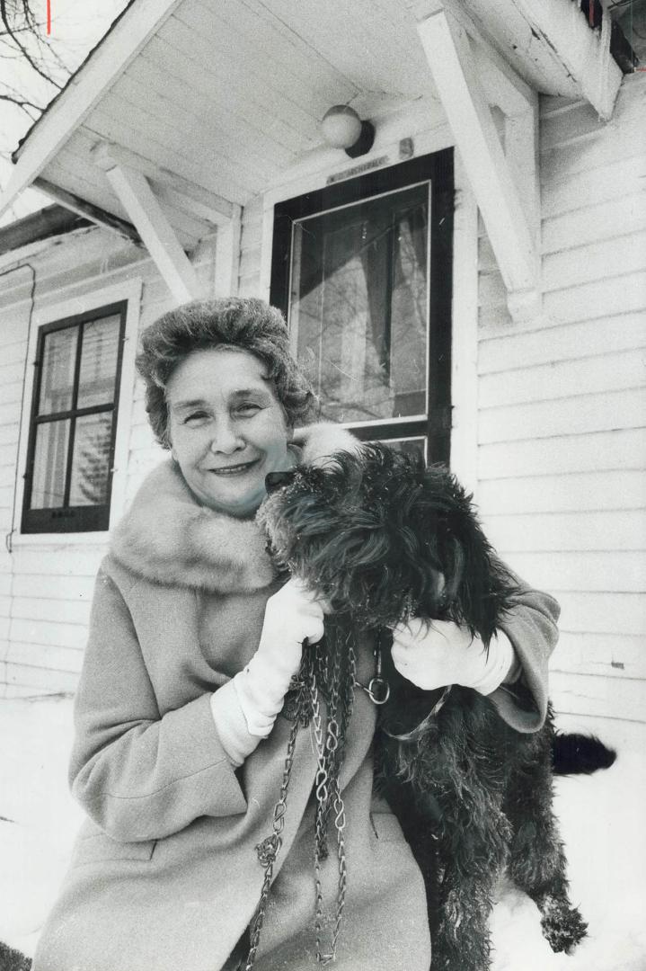 Evelyn Archibald, a 64-year-old Chatham widow who won $480,000 in the Irish Sweepstakes yesterday, takes her son's terrier, Terry, for a walk. She pla(...)