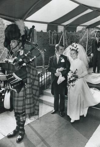 Pipe Major Ross Stewart of the 48th Highlanders of Canada leads Gilbert Flavelle McEachren and his bride, the former Martha Lynn Leith from the church(...)