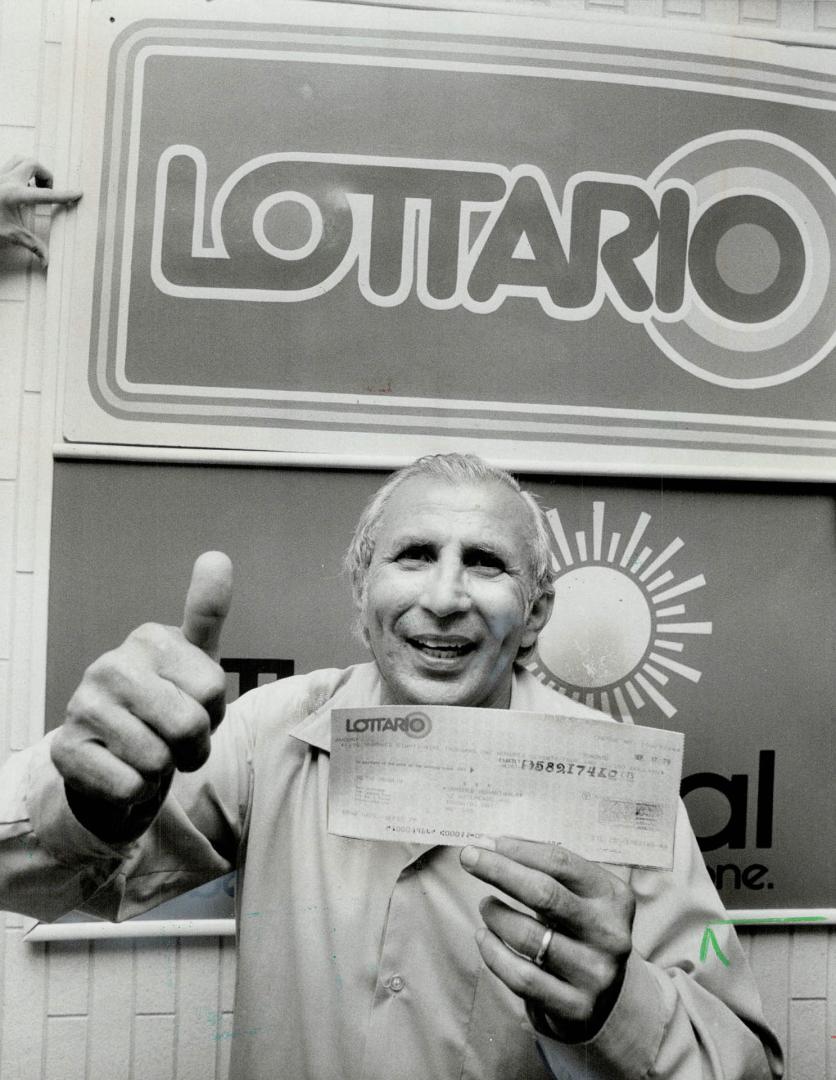 Jackpot!, James Buhariwala, 54 of Toronto, gives the thumbs-up sign after picking up his Lottario jackpot -- a cool $589,169.10 (He also won $5 on a s(...)