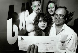 Fortune smiles: Laid-off clerk Grace Costa shows off her lottery winnings with her father Joaquim, best friend Kellie Mitchell and brother Nelson