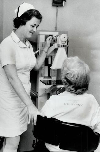 Step two: X-ray technician Mary McAteet adjusts senograph, x-ray machine designed especially to examine the breast, with low-dose x-rays