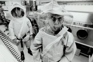 Space-age outfits: Dr. Mohamed Mahdy, right, and technologist Wilson Chaing wear encapsulating suits needed in the event of a spill in the new lab