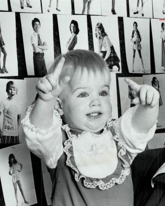 Displaying her poise, 15-month-old Paula Stronach seems to be giving directions to the photographer as she poses in model agency office. Her mother, J(...)