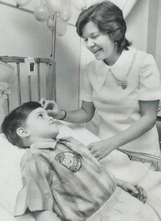Nurse Irma Giese can tell Shawn Butt, 6, a patient at the Hospital for Sick Children, some tales about her experiences working with children in a hospital in Peru