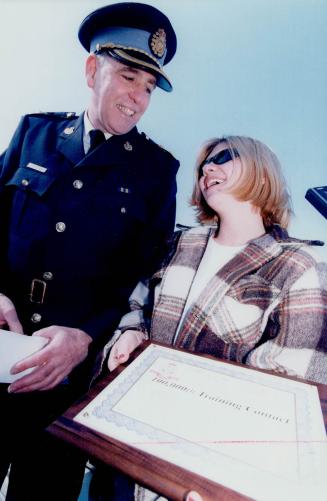 My parents will be so proud': The OPP's Bill Currie awards Deborah Jansen a plaque for being the 100,000th driver stopped by the Highway Rangers