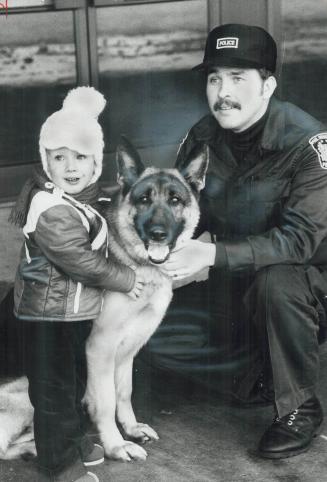 Alexander Cabanus, 2, of Oakville meets Peel Constable Chuck McConnell and police dog Flynn