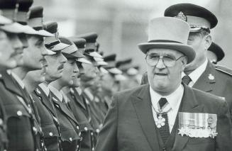 Eyes front! Medal-bedecked Lieutenant-Governor John Black Aird inspects a guard of honor of OPP officers just prior to the opening of the Ontario Legi(...)