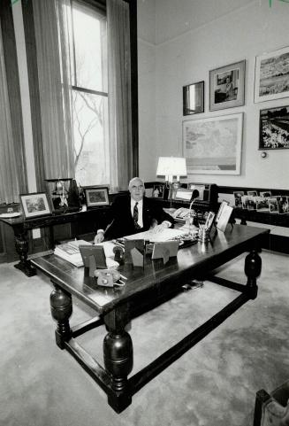 Antique study: Ontario's Lieutenant-Governor John Black Aird sits behind his classic desk