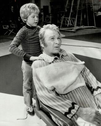 Eddie Albert gets massage from Dennis Larson, Dennis plays Albert's nephew in $1 million TV film produced here