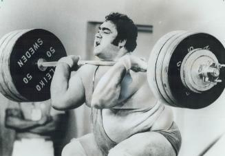 His 21-inch biceps straining, strongman Vasily Alexeev of the Soviet Union takes a breath before completing world record jerk lift of 225 kilos