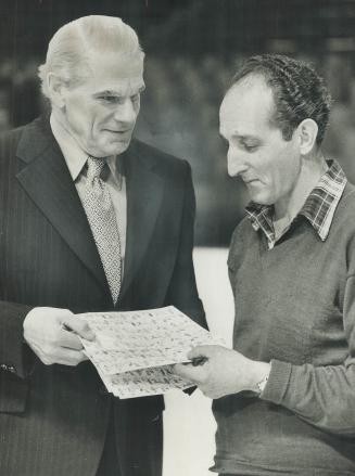 Selling seals on the ice. On the Maple Leaf Gardens ice, maintenance man Peter Bujold buys Christmas Seals from Sylvanus Apps, provincial minister of (...)