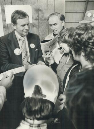 Armstrong signs an autograph for a fan during visit to Ontario in 1978
