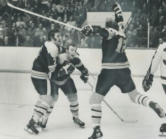 Boston Bruins' Phil Esposito and Wayne Cashman embrace linemate Ken Hodge