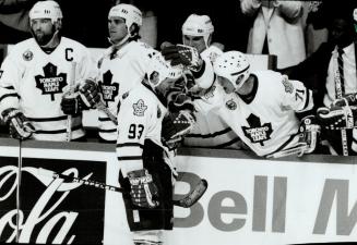 Hang in, Dougie: Veteran Mike Follgno gives Leafs sparkplug Doug Gilmour a few words of encouragement after Marty McSorley rang Gilmour's bell late in the third