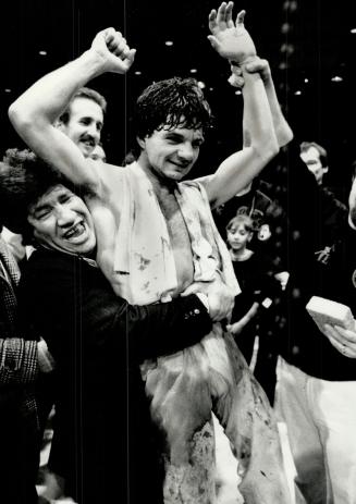 New champion: Paul Biafore of Toronto raises his arms in victory after winning world welterweight kick boxing championship yesterday in Toronto from Richard Hill of Florida