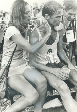 Waterloo's Rich Hughson is comforted by his wife after third-place finish in Pan Am marathon