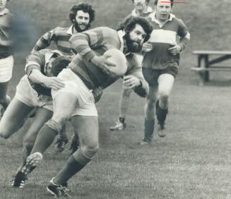 Burlington player is tackled from behind in morning rugby match against Buccaneers