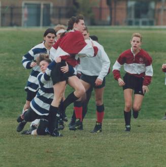 Scrummy effort, Girls from Father Bressani tackle a Unionville player during a York Region high school rugby match yesterday. Father Bressani took it on the chin 30-0. Please see story on page C9