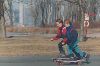 The weather was golden, so Tyler Hasen, 10, left, and his brother Adam, 8, pushed off for a little skateboarding on Toronto Island yesterday, as the m(...)