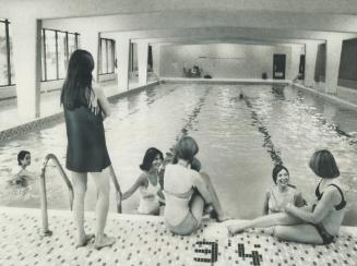 A group of young tenants relax at the indoor pool which is not used as much as some of the other facilitis at Upper Canada Court. An exercise room and(...)