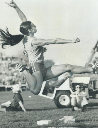 Reaching for distance-Brenda Eisler of Vancouver, a member of the British Columbia Track and Field Association, shows tremendous effort needed to win (...)