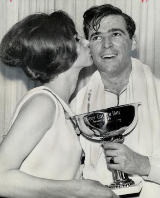 It pays to be a winner. Ingrid Heath has kiss for John Swann