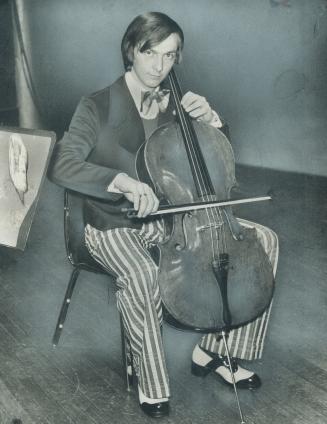 Dave Hetherington, cellist with the Toronto Symphony, wears a navy doublekit jacket, red, white and blue pants and white shirt