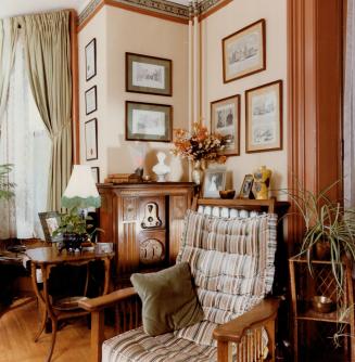 A 19th-century Morris chair provides listening comfort beside an upright Stewart-Warner radio from the 1920s kin the library