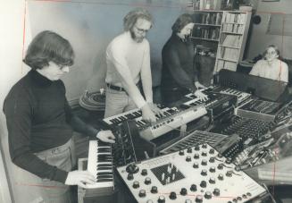 An Electronic Ensemble members - (from id Jaeger, Jim Montgomery, Larry Lake and David Grimes - rehearse in Montgomery's apartment-studio. We're not t(...)