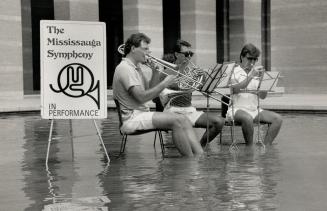 Cool Tunes: Mississauga Symphony nmembers, from left, Thomas Henderson, James Mason and Curtis Dietz, hold a refreshing rehearsal in the city hall pool yesterday