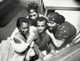 Keying up: Denis Simpson, as legendary jazz pianist Jelly Roll Morton, is surrounded by his ladies - (from left) Arlene Duncan, Cecile Frenette and Jackie Richardson