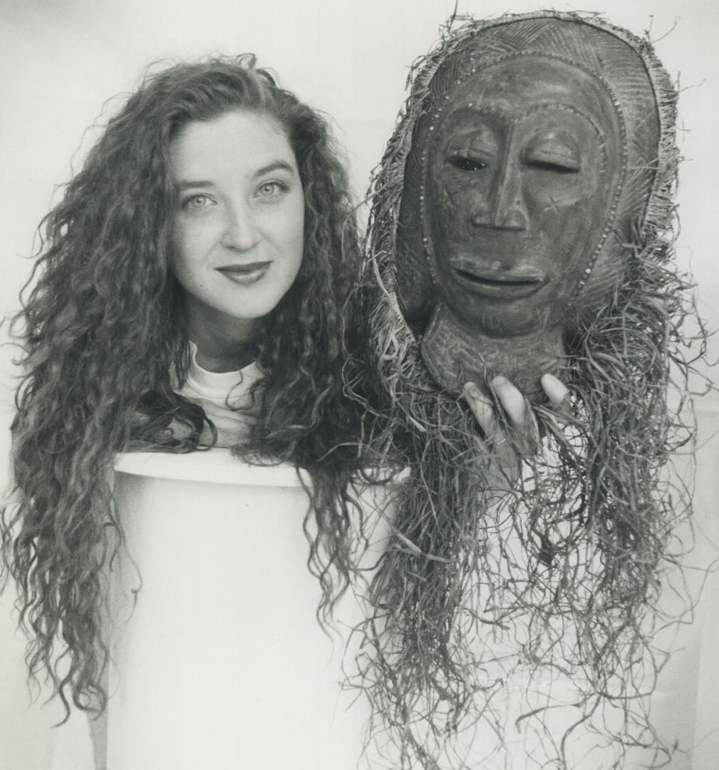 Hair Apparent. Jennifer Tarrant, a Sheridan College art student, holds a bridegroom mask from the African Zaiols tribe at a Harbourfront auction yeste(...)
