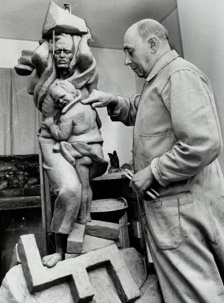 Harry Ostrzeja and a sculpture done in his leisure time