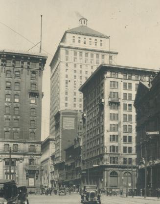 A glimpse of St. James St., Montreal, which is sometimes called The Wall Street of Canada. The tall building in centre is the new Royal Bank