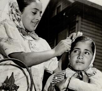 One Little Sikh girl does a hair-do operation for another outside the Sikh temple in Vancouver