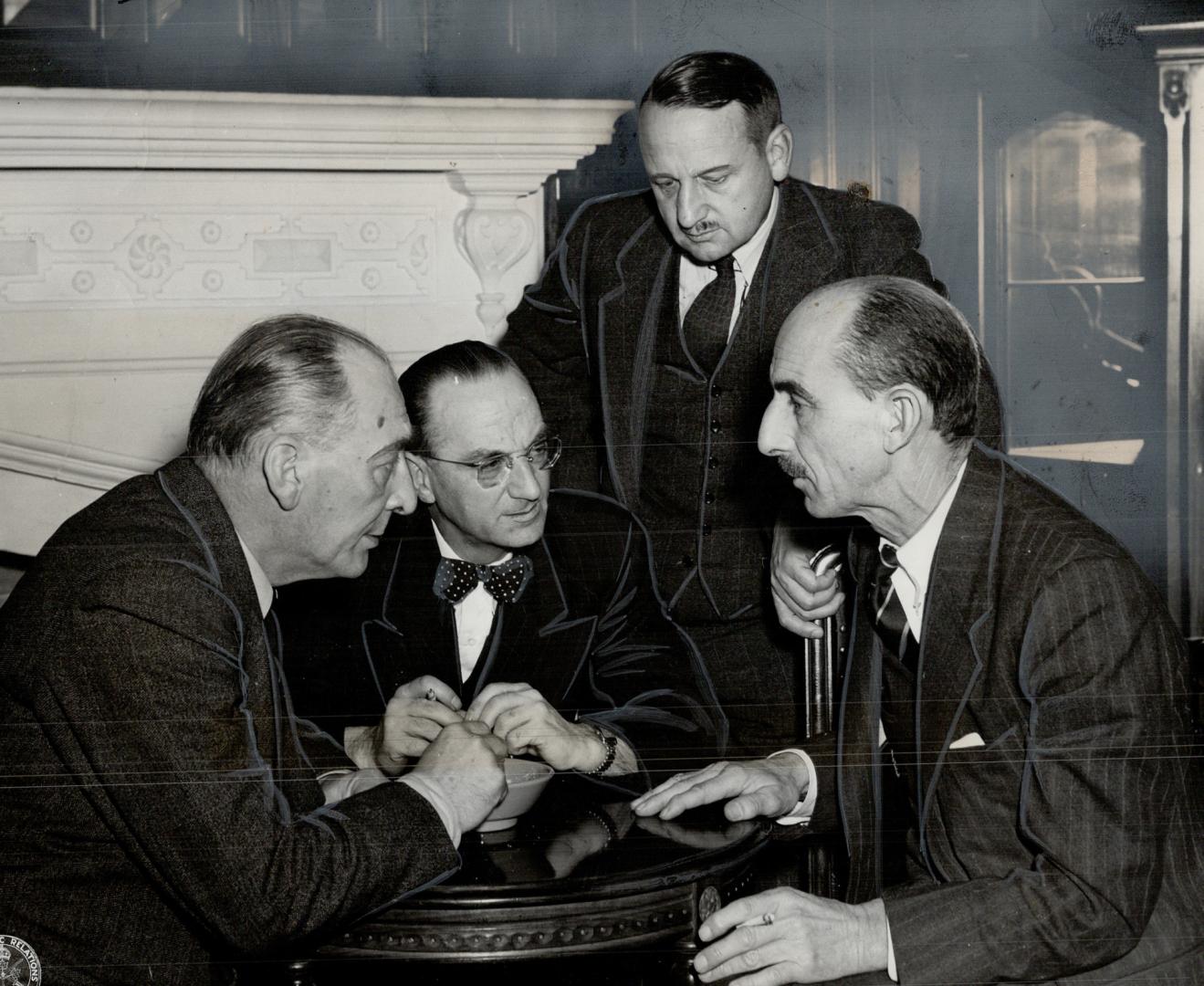 F. G. Bradley, left, and Joseph Smallwood, centre, Newfoundland union delegates, at Ottawa, chat with Maj.-Gen. E. L. M. Burns, veterans' affairs depu(...)