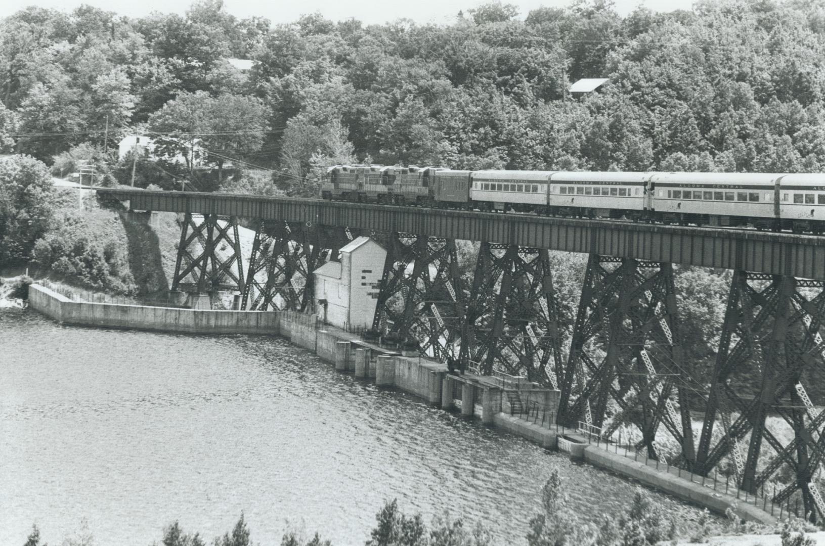 Railway tracks and trains winding through the Canyon and crossing the Montreal River
