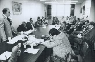 View of boardroom with some board members and Miller during their meeting