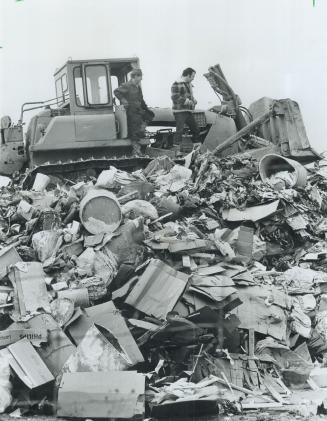 A bulldozer flattens a huge mound of garbage at the Chinguacousy Township municipal garbage dump north of Bramalea