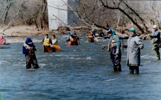 Kayak and canoe racers test their skills on a slalom course set up on the Credit River in Mississauga yesterday as fishermen try their luck on the str(...)