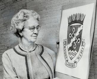 New coat of ARMS for Halton Region, displayed by its designer, Dorothy Stone, Halton Hills artist, carries the country's traditional motto: Without Ef(...)