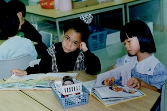 There's a lesson in this, The heady days of summer play end for classmates Latoya Duarte-Defreitas, left, and Ninettee Cheng, who read picture books d(...)